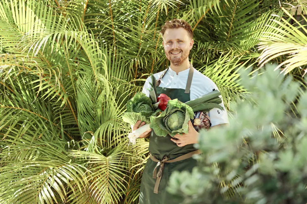 The chef of Coquille restaurant holding vegetables